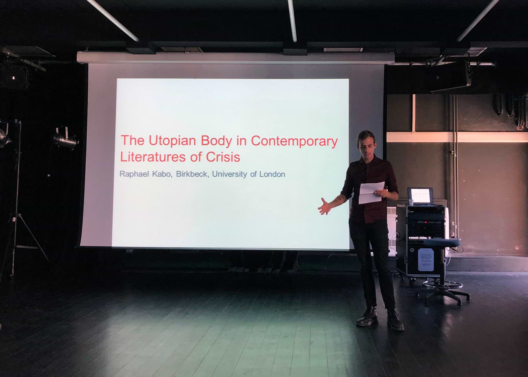 Photograph of me presenting my paper 'The Utopian Body in Contemporary Literatures of Crisis' at BACLS 2018, Loughborough University, UK