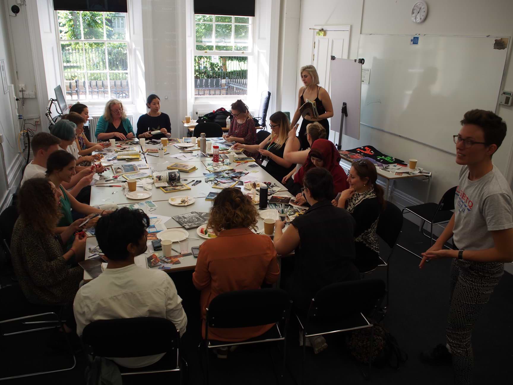 Photograph of the band Dream Nails running a zine-making workshop at Utopian Acts 2018